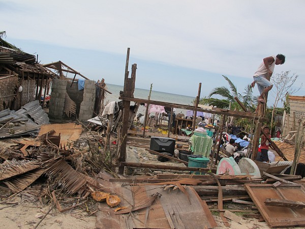 Survivors attempt to build a temporary shelter from debris after super-typhoon Yolanda devastated parts of the central Philippines. (Photo Credit: Moises Musico)